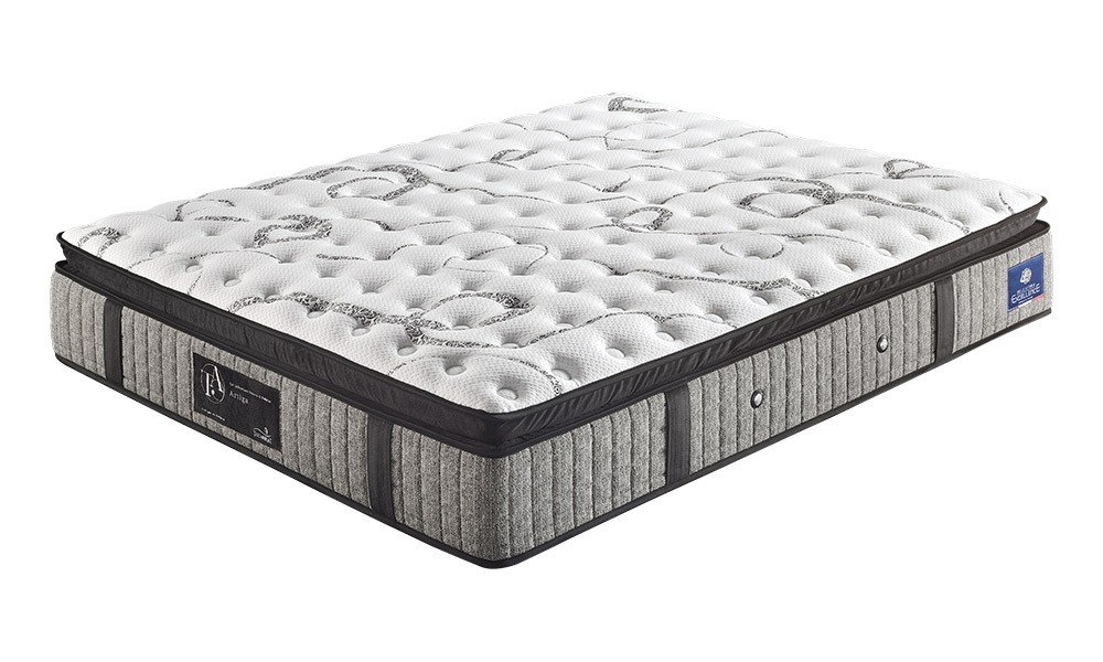 Un matelas moelleux avec un dessus matelassé blanc et des côtés rayés gris, arborant un logo sur le coin, incarnant la qualité parisienne. Canape Paris by Atelier Bis