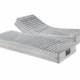 Deux matelas gris réglables d'une qualité exceptionnelle, l'un plat et l'autre surélevé, présentés sur un fond blanc immaculé. Canape Paris by Atelier Bis