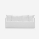 Un canapé blanc minimaliste avec cinq coussins assortis respire la qualité sur un fond uni. Canape Paris by Atelier Bis