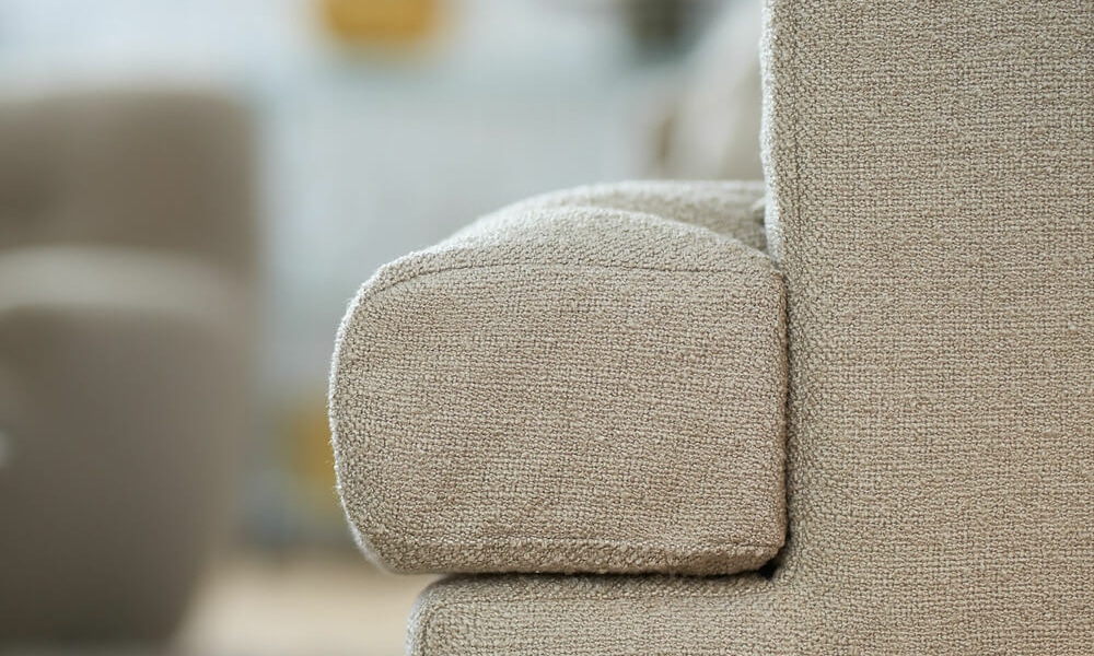 Un salon moderne avec un canapé en cuir gris, des tables basses en métal et un éclairage minimaliste.