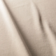 Tissu beige texturé avec des plis subtils et des ombres qui courent en diagonale sur la surface. Canape Paris by Atelier Bis