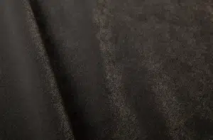 Gros plan sur un tissu en daim marron foncé à la texture douce et au pli diagonal subtil. Canape Paris by Atelier Bis