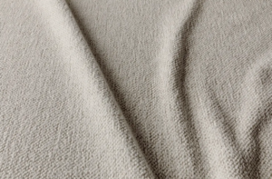 Gros plan sur un tissu beige texturé, à la surface douce et bosselée et aux plis délicats. Canape Paris by Atelier Bis