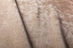 Gros plan d'un tissu velouté beige, à la texture douce et à la brillance subtile, montrant un pli central. Canape Paris by Atelier Bis