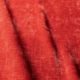 Gros plan sur un tissu rouge texturé, aux plis souples et à l'aspect légèrement usé. Canape Paris by Atelier Bis